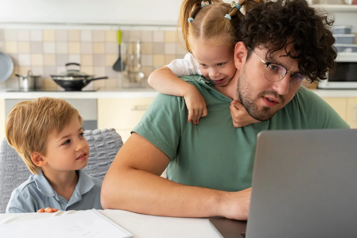 A parent working from home while caring for two young children